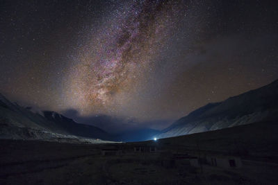 Scenic view of mountains against sky at night