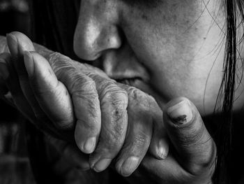 Cropped image of woman kissing parent hand