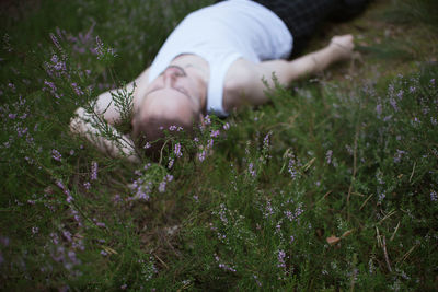 Midsection of woman lying down on field