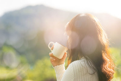 Young woman using smart phone outdoors