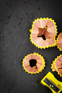 High angle view of yellow flower on table