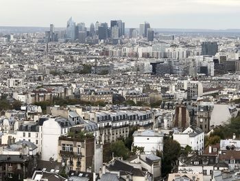 High angle view of buildings in city against sky