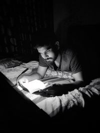 Man reading book on bed