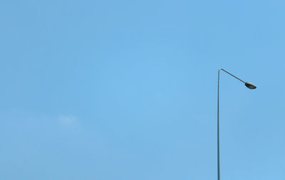 Low angle view of street light against clear blue sky