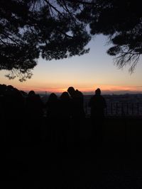 Silhouette of men against sky during sunset