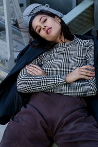 Portrait of smiling young woman sitting outdoors