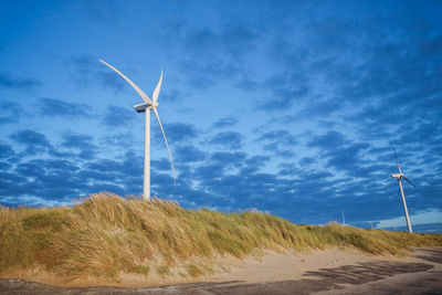 Windturbine in a holland countryside at sunset