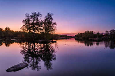 Scenic view of lake against sky at sunset