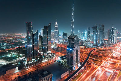 Aerial view of illuminated buildings in city at night