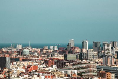 Buildings in city against clear sky