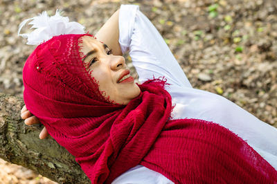 Young woman wearing red hijab in public park