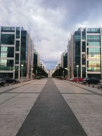 Street amidst buildings in city against sky