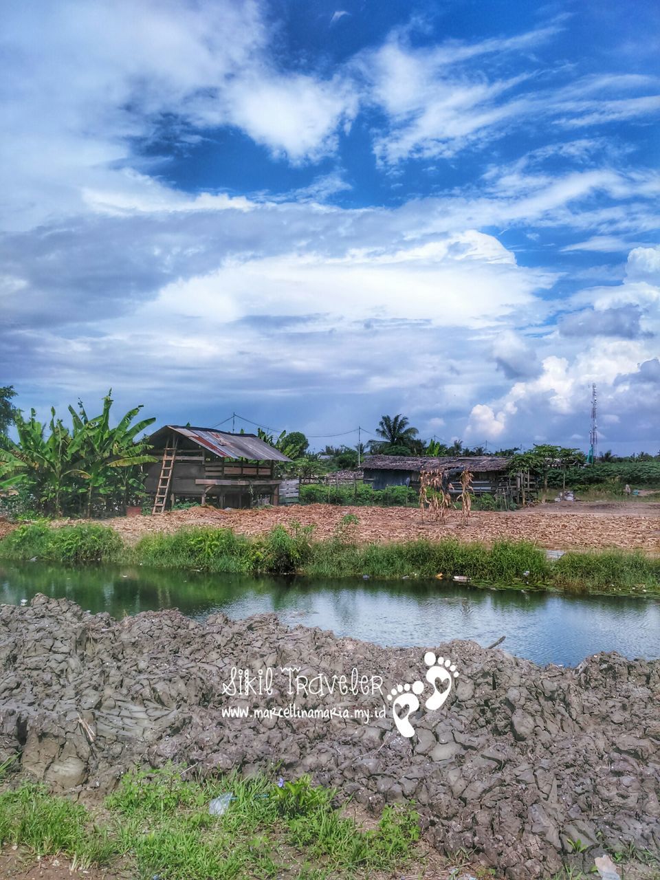 sky, water, cloud - sky, built structure, architecture, cloud, building exterior, plant, grass, tranquility, tranquil scene, nature, cloudy, lake, day, river, landscape, scenics, tree, beauty in nature