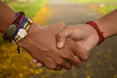 Close-up of friends shaking hands