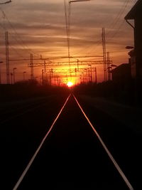 Electricity pylon against sky during sunset