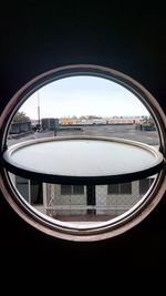 Reflection of bridge in city against sky