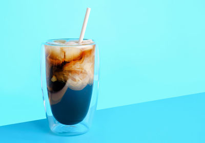 Close-up of drink against blue background