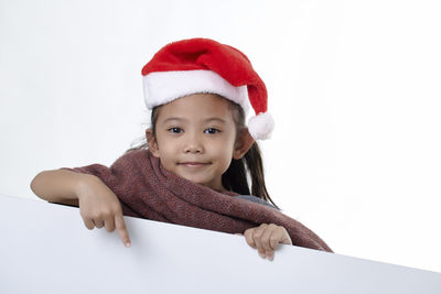 Portrait of cute girl wearing hat against white background