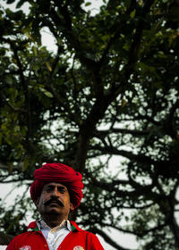 Low angle view of man standing against trees