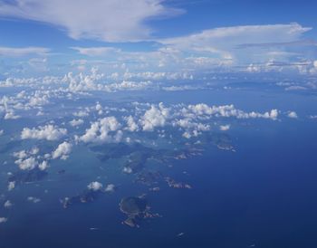 Aerial view of sea against blue sky