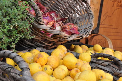 Lemons in basket at market for sale