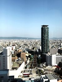 High angle view of modern buildings in city against clear sky