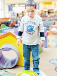 Full length of boy standing at camera