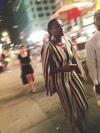 Blurred motion of man walking on city street