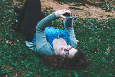 Portrait of young woman lying on grass