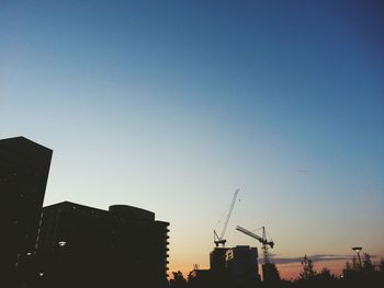 Low angle view of buildings at sunset
