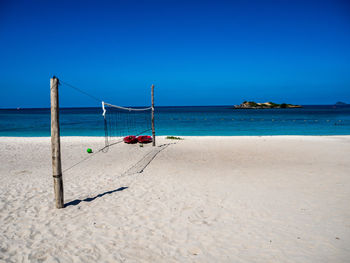 Scenic view of beach against clear blue sky