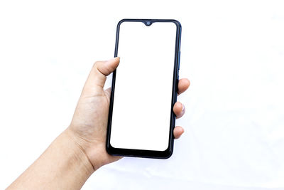 Midsection of person using mobile phone against white background