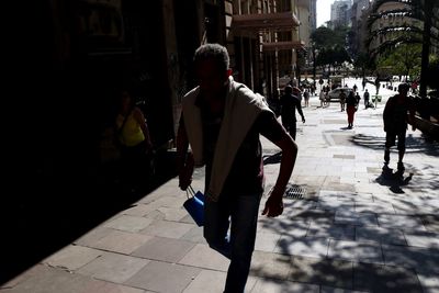 Rear view of people walking on street