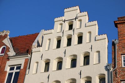 Low angle view of historic building against blue sky