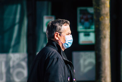 Portrait of man standing against wall