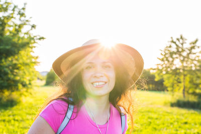 Portrait of smiling woman against sky on sunny day
