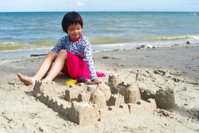Girl making sandcastle at beach