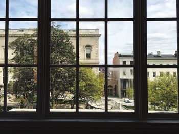 Buildings and trees seen from glass window