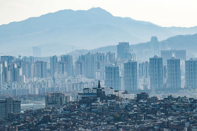 High angle view of buildings in city against sky