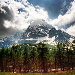 Scenic view of mountains against cloudy sky