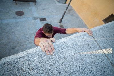 High angle view of man with arms raised