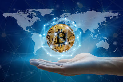 Low angle view of hand holding illuminated light