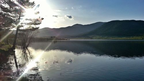Scenic view of lake and mountains against sky
