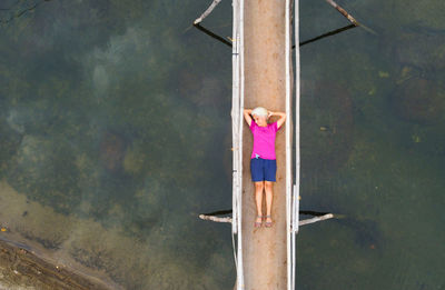 Aerial view of woman sleeping on a bridge 