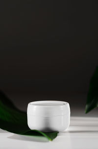 Close-up of tea cup on table against black background