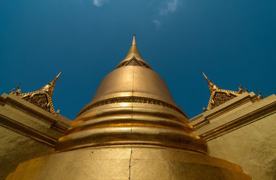 Low angle view of religious structure against blue sky