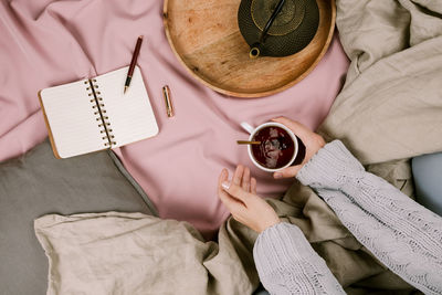 High angle view of woman holding book