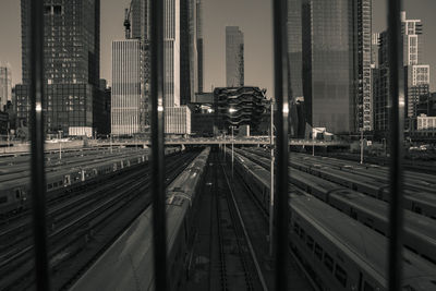 High angle view of railroad tracks by buildings in city at night
