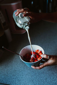 Midsection of woman preparing food in bowl