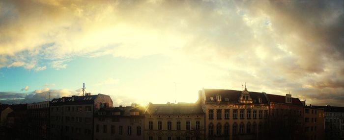 Buildings against cloudy sky